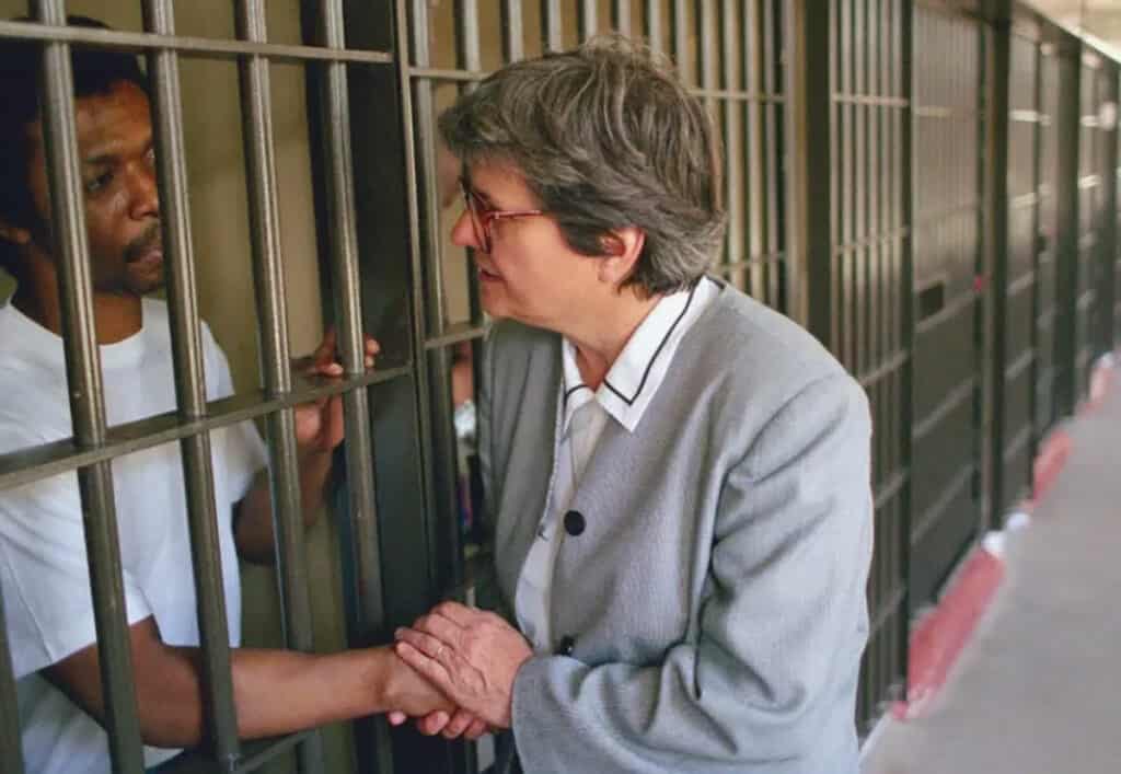 Sister Helen Prejean with a man in prison